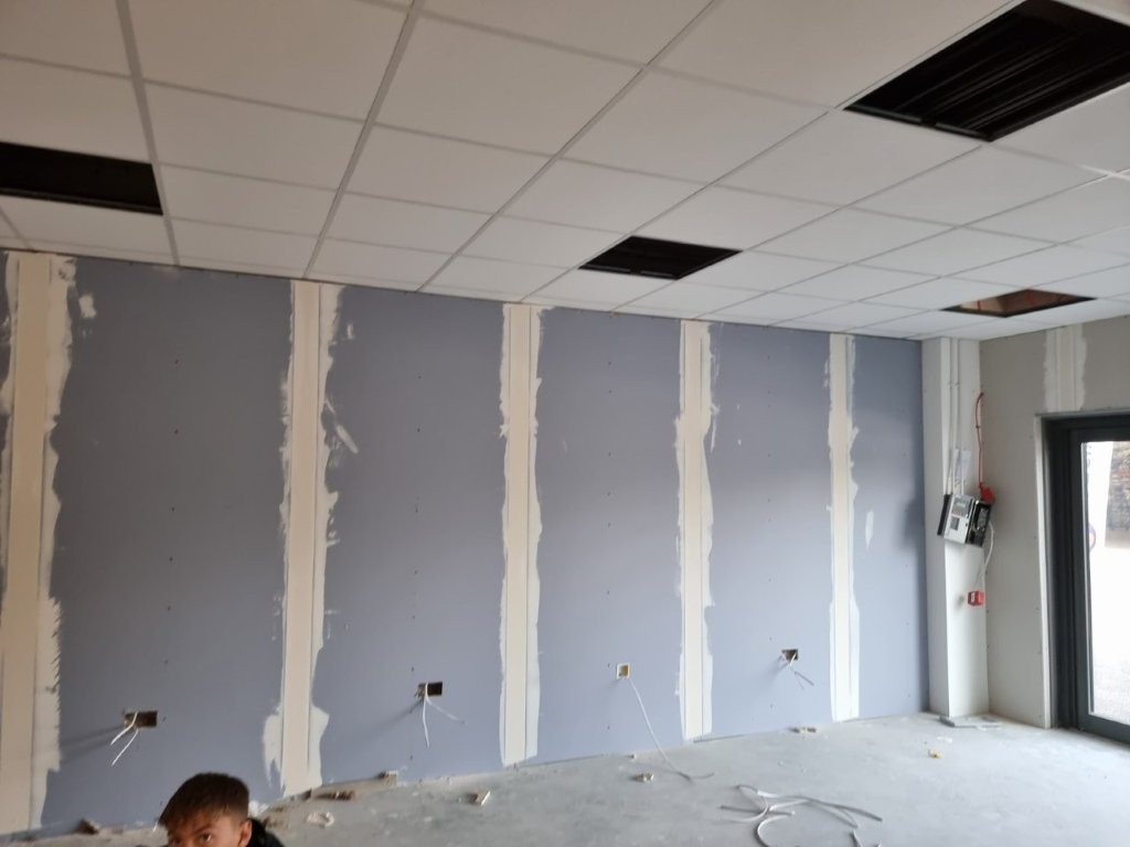 Grey sound bloc board on party wall.