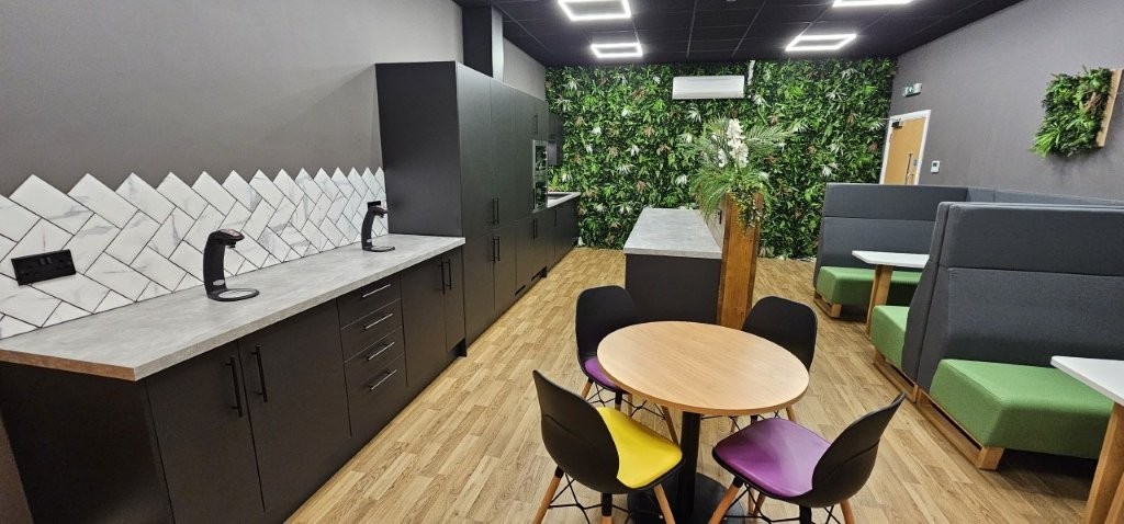 The finished breakout space with purple and yellow seat pads on the dining table