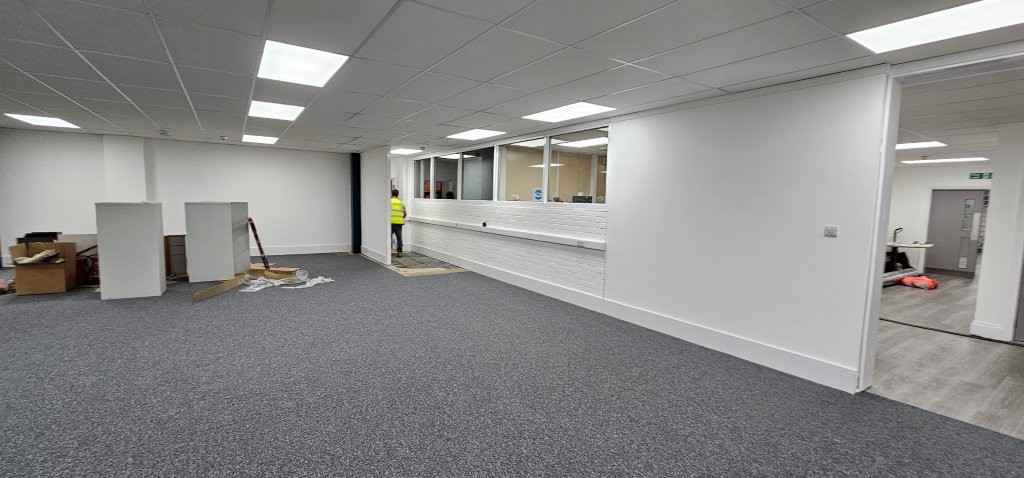 Clean white walls, new suspended ceiling and new grey carpet tiles