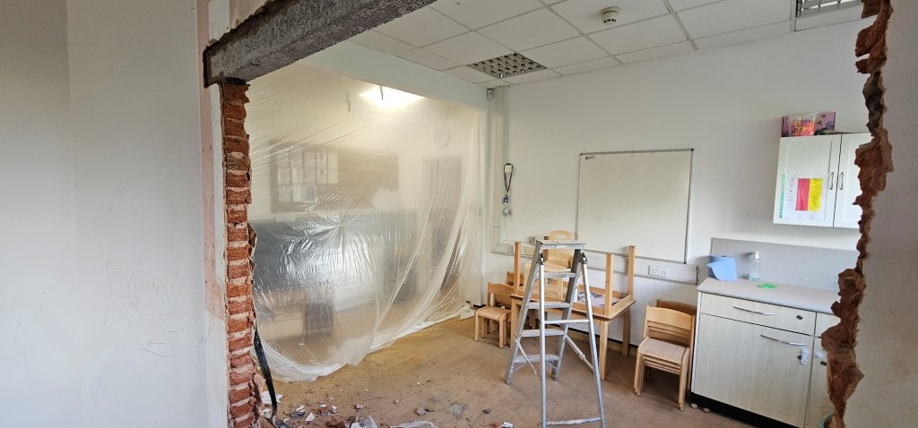 Rest of area sheeted off to prevent dust